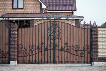 Wall Mural - Metal wrought brown gates with decorative elements in a private house