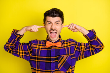 Canvas Print - Photo of young man unhappy irritated annoyed close ears fingers loud noise isolated over yellow color background