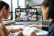 © Kateryna - Online business meeting, brainstorm. View over the shoulders of two women to a computer screen with different successful multiracial people gathered in a video conference to discuss working issues