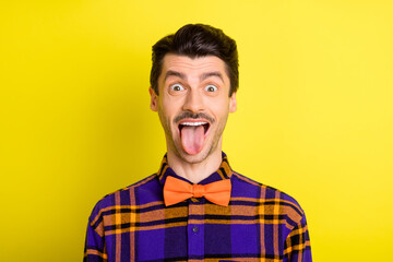 Sticker - Photo of young man happy positive smile fooling grimace tongue-out silly funny isolated over yellow color background