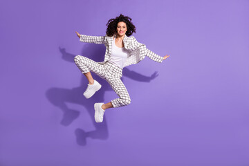 Sticker - Full length photo portrait of cheerful girl jumping up isolated on vivid purple colored background