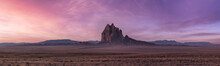 Panoramic American Nature Landscape View Of The Dry Desert And Rugged Rocky Mountains. Colorful Sunrise Sky Art Render. Taken At Shiprock, New Mexico, United States.