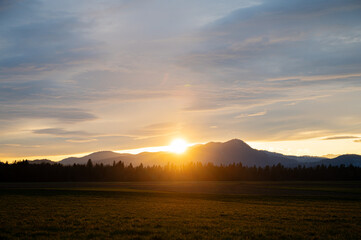 Beautiful sunset with the sun setting behind the hills