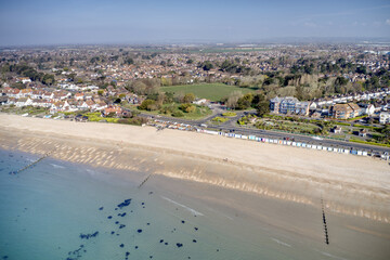 Wall Mural - A row of brightly coloured beach huts in Bognor Regis with Marine Park Gardens and Aldwick West Park in the background. Aerial View.