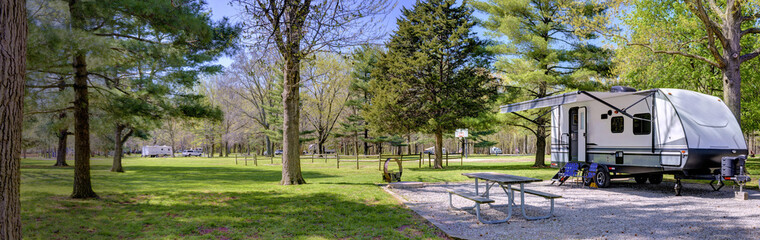 travel trailer camping in the woods at a campground