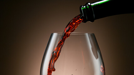 Wall Mural - Detail Shot of Pouring Red Wine from Bottle