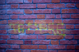 Fototapeta Boho - Old rusted purple brick wall with covered with paint and yellow graffiti