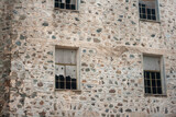 Fototapeta Boho - Old ruined abandoned dark brick wall with broken windows 