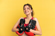 © luismolinero - Young caucasian woman isolated on blue background with boxing gloves