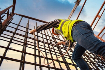 Construction workers wear safety harnesses and harnesses to work at heights during disease (COVID-19).