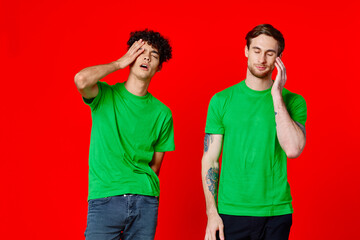 two man holding his neck emotions discontent red background