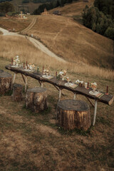 Wall Mural - Vertical shot of a wedding table with floral, ceramic arrangements, candles and cutlery in the field