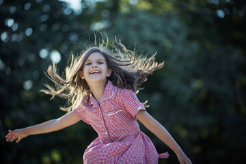 Summer is awesome. Little happy girl spending time in nature.