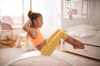 © liderina - Little girl doing yoga exercise at home on board.