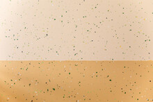 Closeup Of A Beige Background Wall With Green Speckles