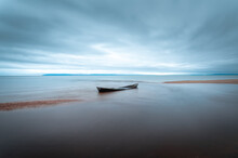 Lone Boat With Cloudy Weather With Long Exposure