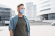 © kite_rin - Man wearing protective face mask in a city, Masked caucasian man on a city street closeup portrait, Pandemic, corona virus protection, healthy lifestyle, self-care, people concept
