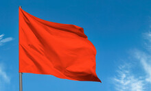 Bright Red Flag Waving Against Blue Sky, Blank Red Banner