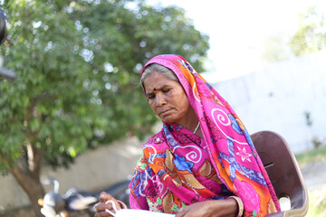 Poster - Closeup shot of an Indian woman keeping a white mask on his hands