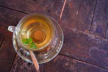 Sticker - Top view of a cup of green tea on the wooden surface