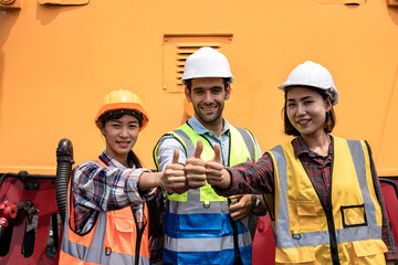 A group of workers holding hands for show like or good of engineers and rested on the tracks and bright smile. Teamwork engineer work together in a construction railway. 