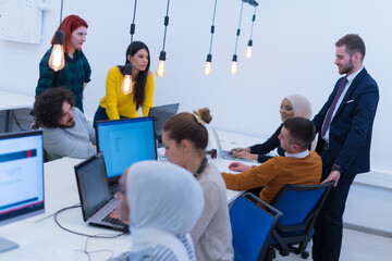 Wall Mural - Creative multiethnic business people group as freelancers in modern coworking open space office working together