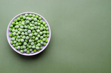 Fresh frozen peas in white bowl. with copy space