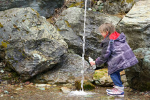 Little Child Playing In Spring Water