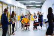 Friendly work team ride chairs in office room cheerfully excited diverse employees laugh while enjoying fun work break activities, creative friendly workers play a game together.