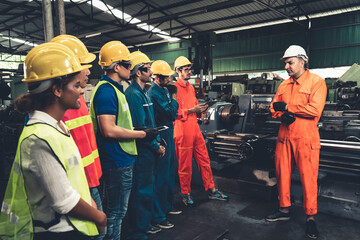 Skillful worker attending brief meeting in the factory . Industrial people and manufacturing labor concept .