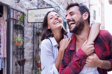 Wall Mural - Happy love couple walking in town