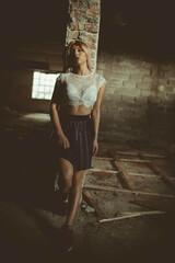 Poster - Attractive female wearing a white lace crop top and black skirt