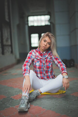 Wall Mural - Shallow focus shot of an attractive Bosnian female sitting on a floor and posing for the camera