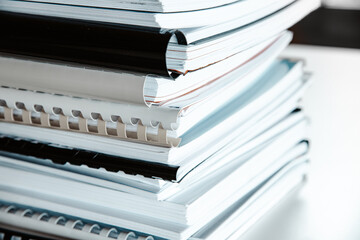 Wall Mural - Stack of reports lies on a desk ready for review