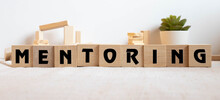 Mentoring - Word From Wooden Blocks With Letters, Help And Advice Mentoring Concept.