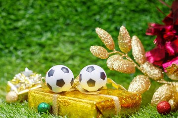 Wall Mural - Soccer ball for Christmas Decoration are on green grass 