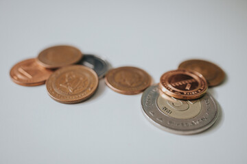 Selective focus shot of the convertible mark coins on a white table