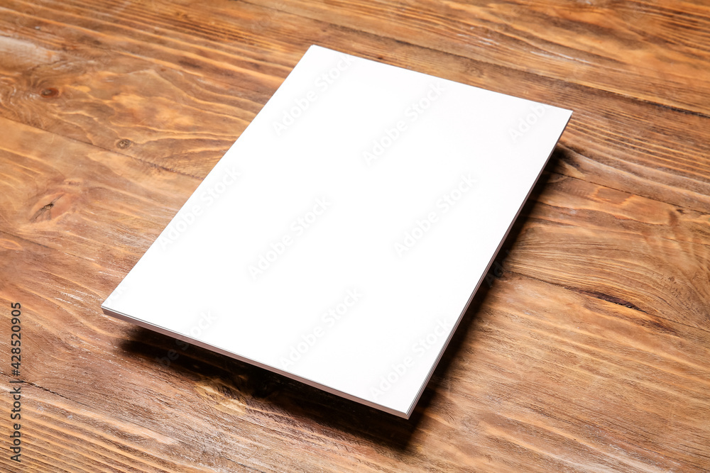 Blank sheet of paper on wooden background