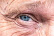 © CL-Medien - Close-up macro view on the blue eye of senior man smiling