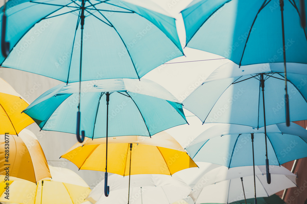 rainy season concept, umbrella use for sunshade public space decoration pattern background - obrazy, fototapety, plakaty 