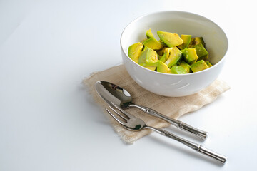 Fresh sliced avocado in white bowl