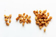 handfuls of white bread croutons on a light background close-up