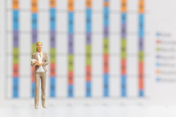 Miniature Business Woman standing on business graph background , Business growth concept