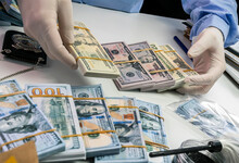 Specialised Police Officer Counting Dollar Banknotes In Crime Lab, Conceptual Image