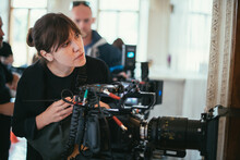 Female Director Of Photography With A Camera On A Movie Set. Professional Videographer On The Set Of A Movie