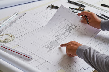 Architect engineer contractor design working drawing sketch plan blueprint and making architectural construction house building in architect studio.