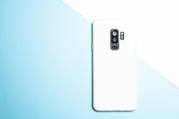 Sticker - Rearview of a smartphone isolated on a white and blue surface