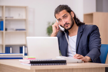 Young male employee working in the office