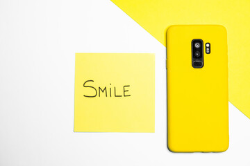 Canvas Print - Closeup shot of a mobile phone and a sticky note with 