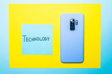 Wall Mural - Closeup shot of a mobile phone and a sticky note with 